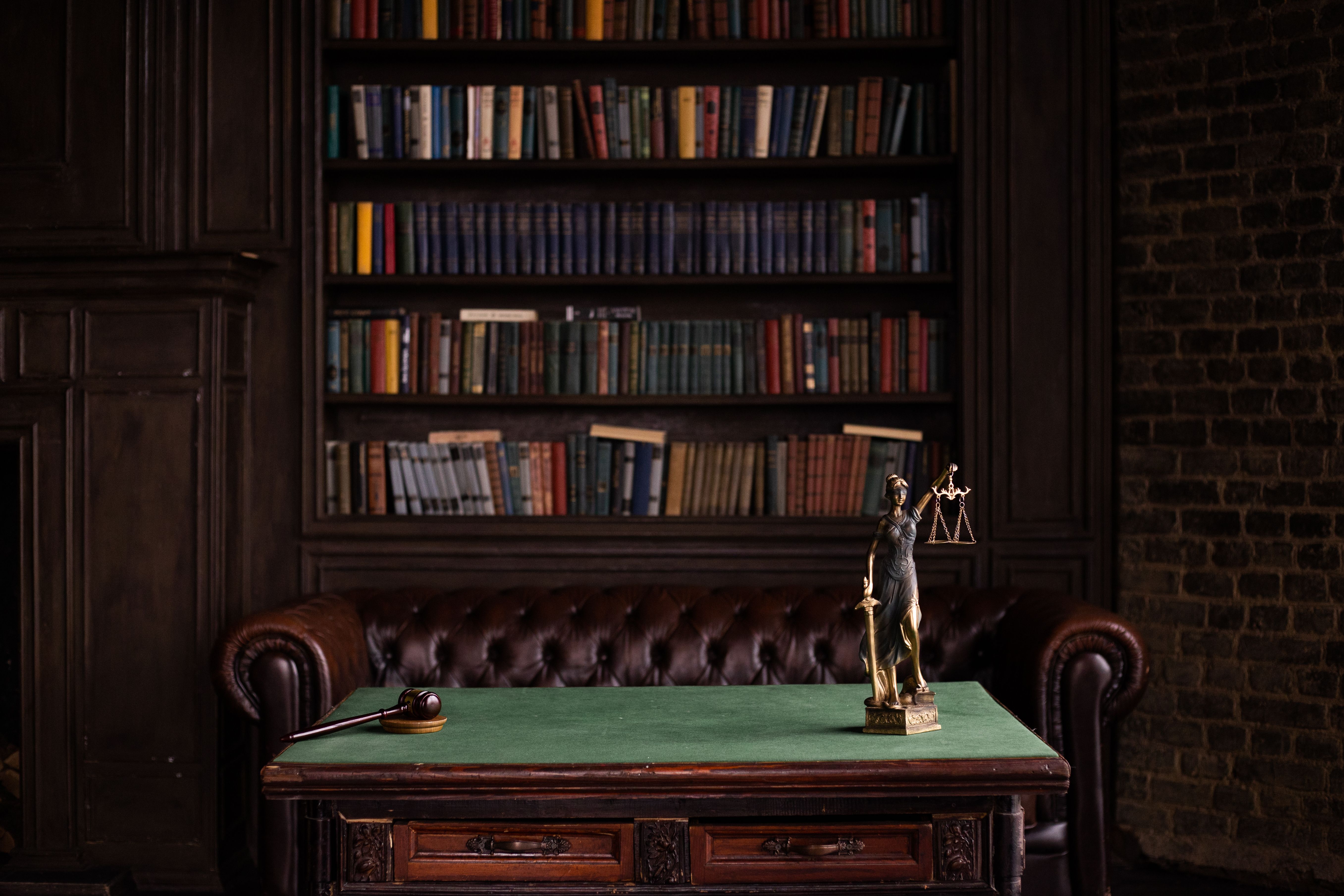 Legal study with shelves of law books, a gavel, and a Lady Justice figurine symbolizing complex litigation